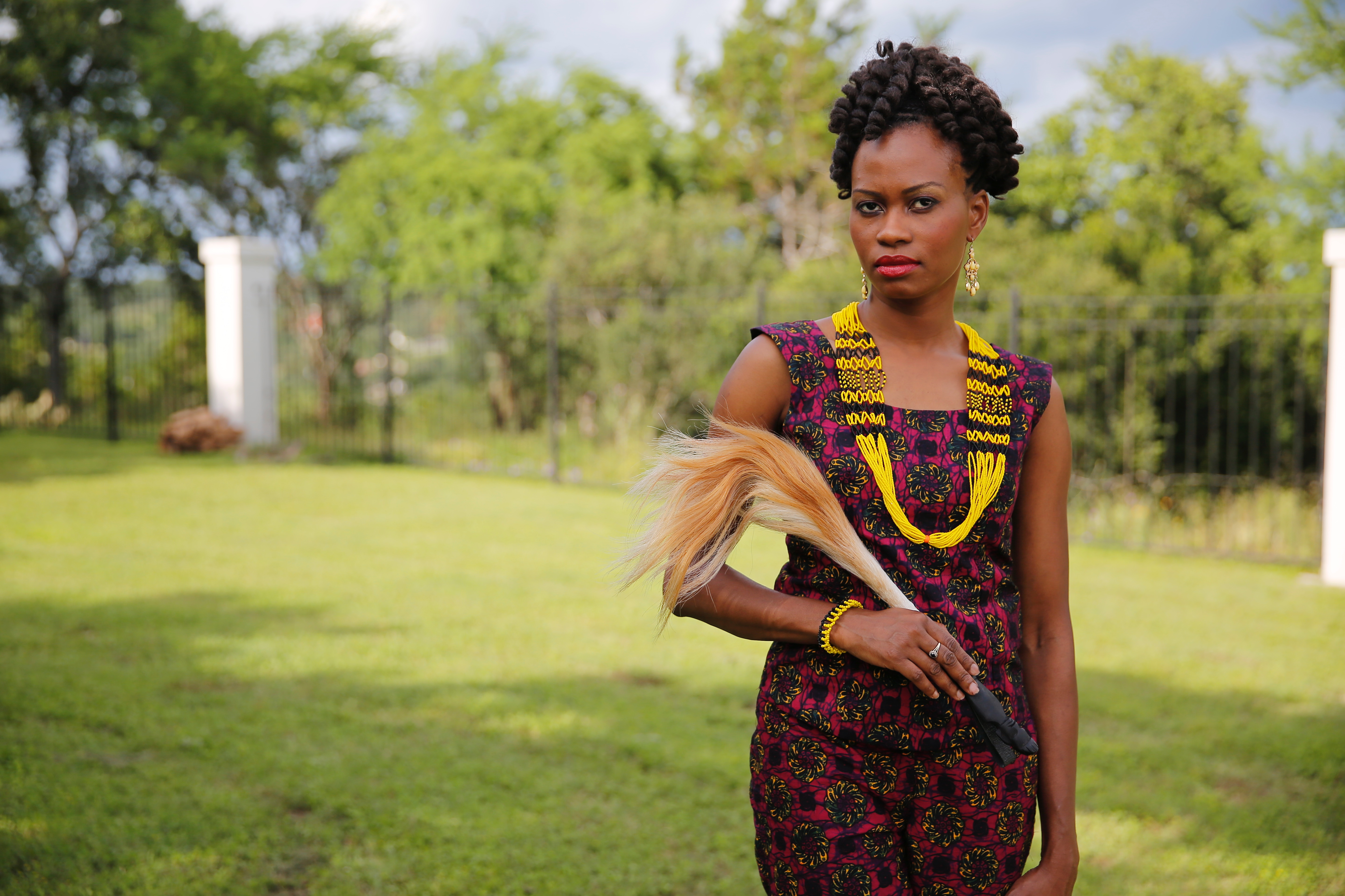 Noela Mogga in African print and South Sudanese beaded necklace and bracelet 