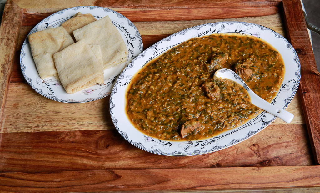 Rijla; purslane with red lentils stew serve with Kisra